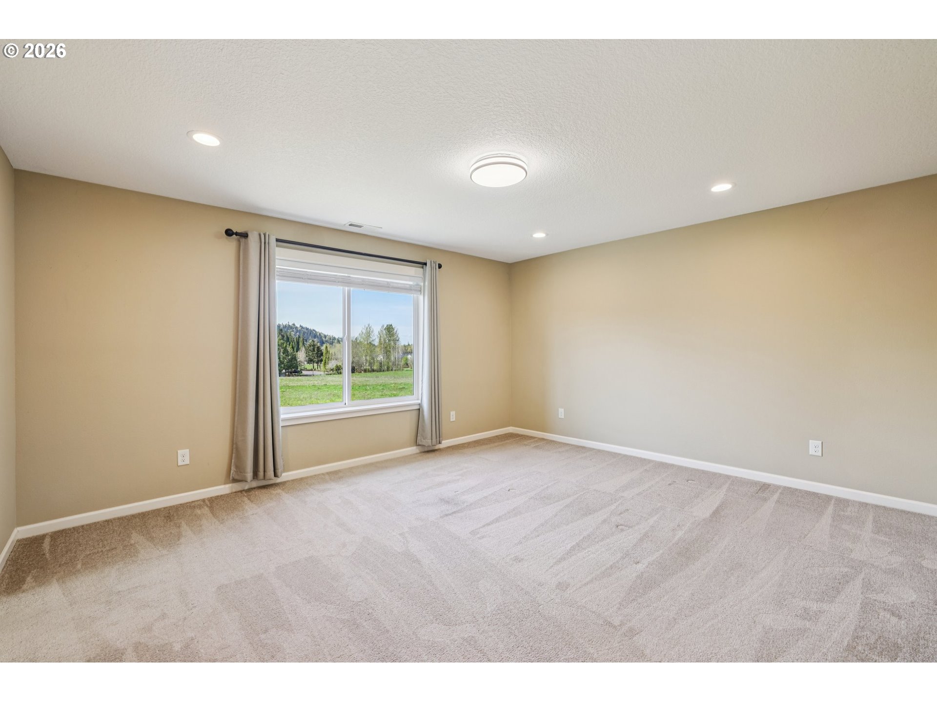 2117 Southeast Cochran Drive Gresham, OR 97080 - Photo 24 of 48 a view of an empty room with wooden floor and a window