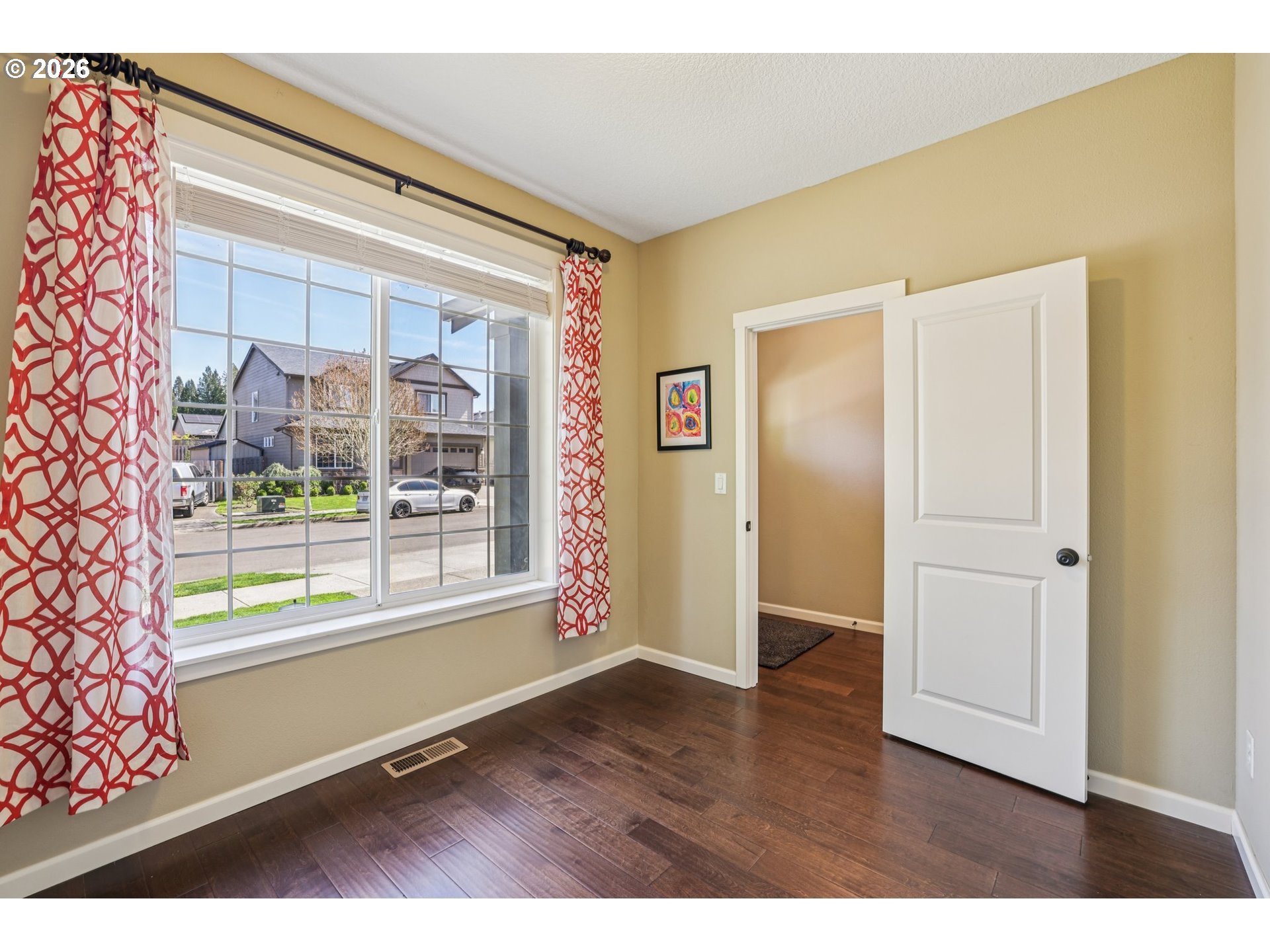 2117 Southeast Cochran Drive Gresham, OR 97080 - Photo 9 of 48 a view of an empty room with a window and wooden floor