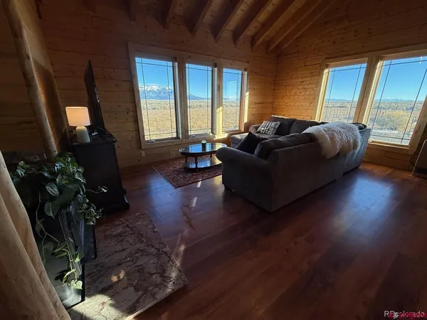 a living room with furniture window and wooden floor