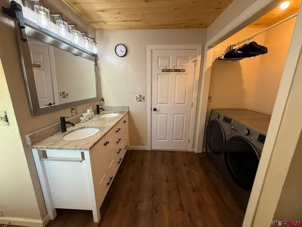 a bathroom with a sink a washer and dryer