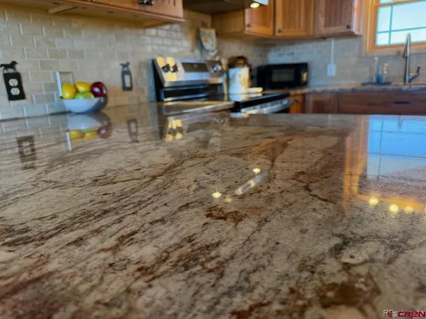 a kitchen with granite countertop lots of clutter and cabinets