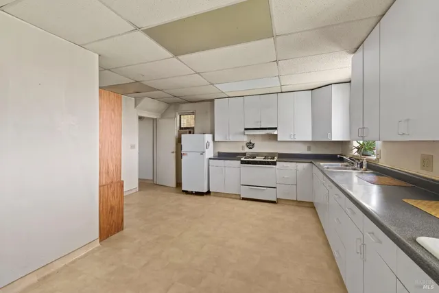a large kitchen with cabinets and stainless steel appliances