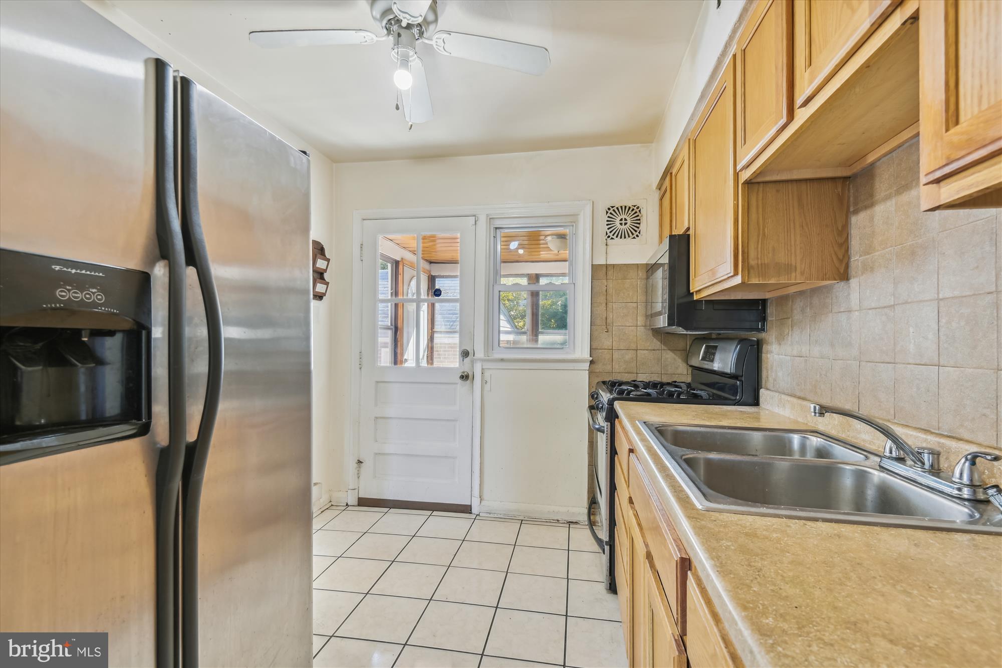 3415 Mayfair Road Gwynn Oak, MD 21207 - Photo 10 of 35 a kitchen with stainless steel appliances granite countertop a refrigerator a sink and white cabinets