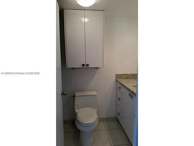 a bathroom with a toilet a sink and a shower