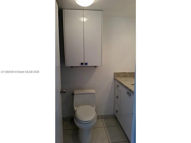 5401 Collins Avenue, Unit 829 Miami Beach, FL 33140 - Photo 15 of 29 a bathroom with a toilet a sink and a shower