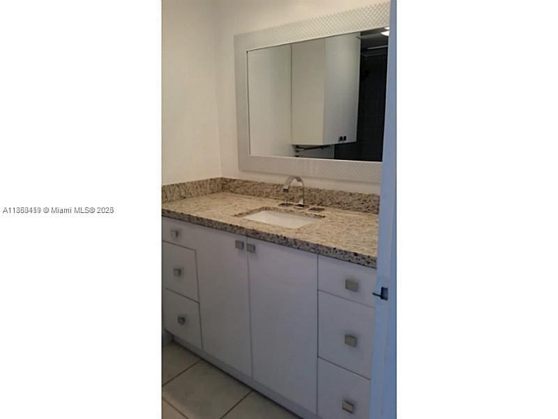 5401 Collins Avenue, Unit 829 Miami Beach, FL 33140 - Photo 16 of 29 a bathroom with a sink and a mirror