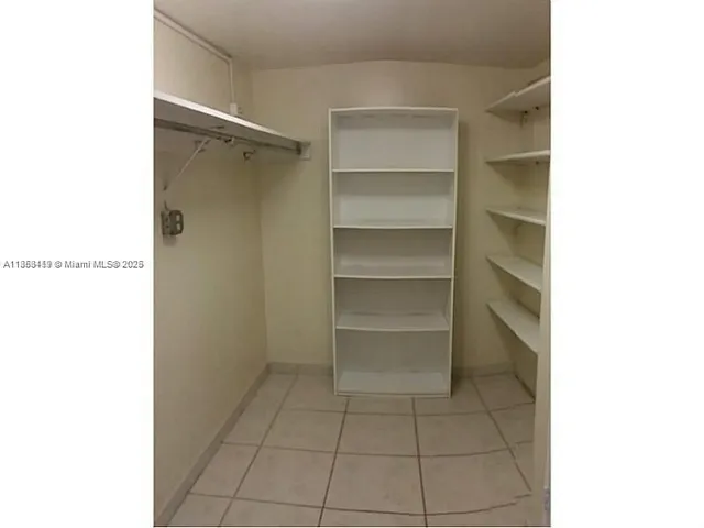 a bathroom view with a sink and a mirror