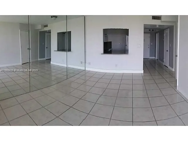 a kitchen with a stove and white cabinets