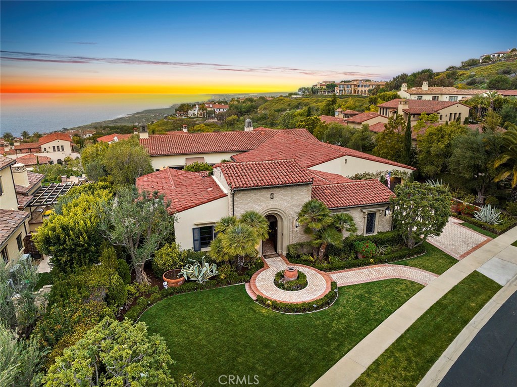 an aerial view of a house with garden space and street view