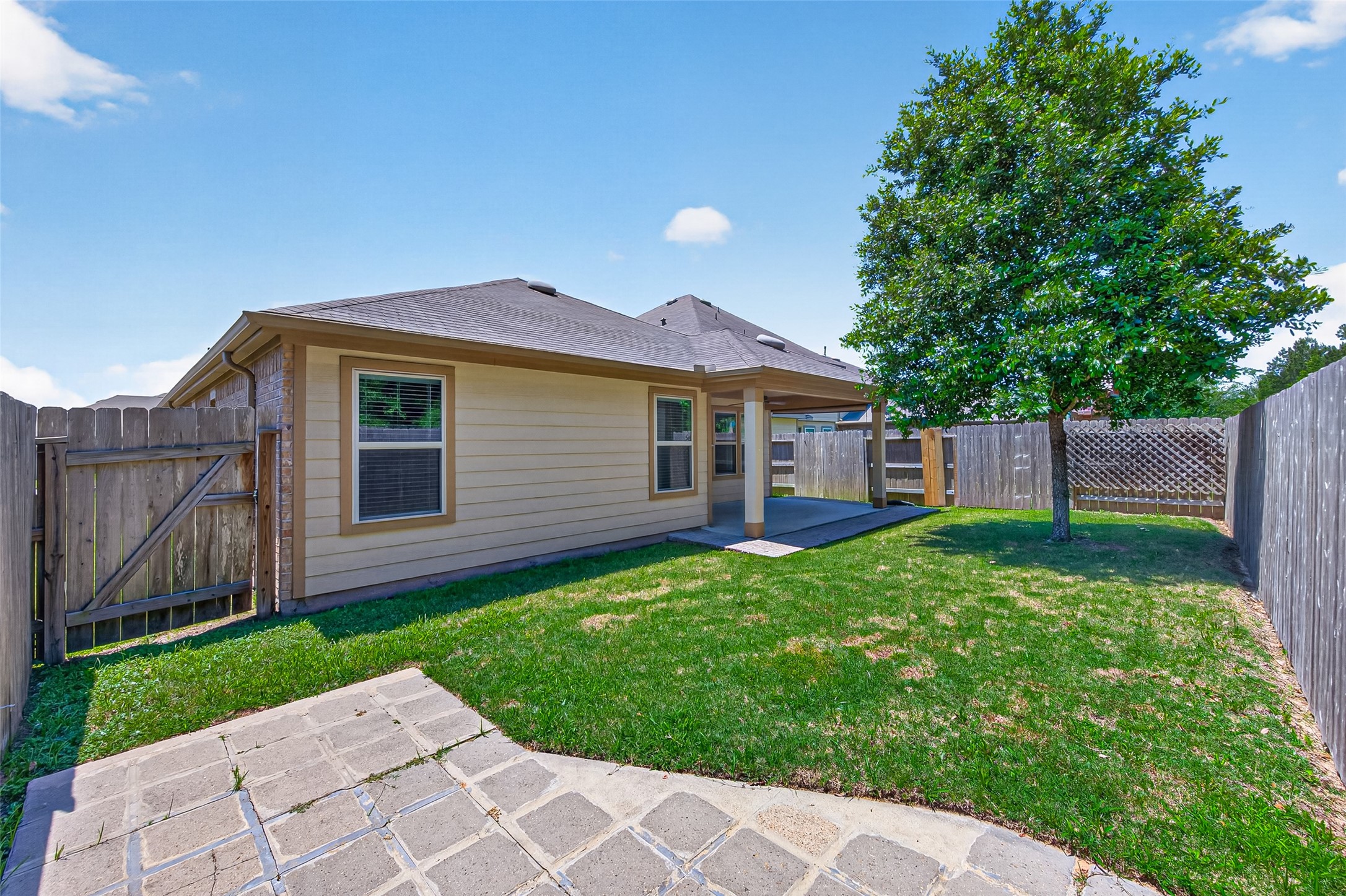 2754 Cayden Creek Way Conroe, TX 77304 - Photo 34 of 40 a view of a house with a yard