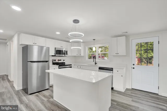 a kitchen with a refrigerator a sink dishwasher with a stove and refrigerator