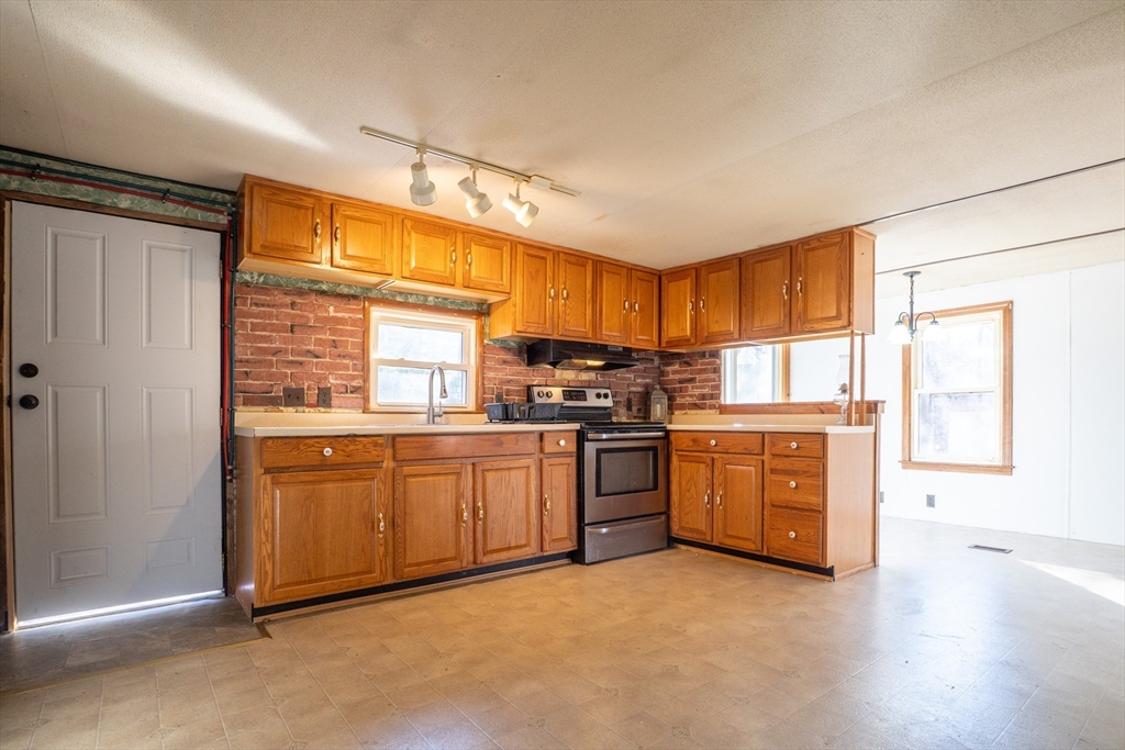 238 Brookfield Road Brimfield, MA 01010 - Photo 3 of 28 a kitchen with granite countertop stainless steel appliances a refrigerator cabinets and wooden floor