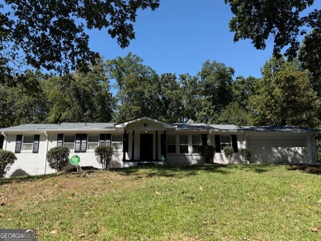4405 Bakers Ferry Road Southwest Atlanta, GA 30331 - Photo 1 of 18 a view of a house with a yard and sitting area