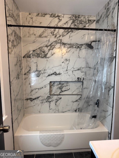4405 Bakers Ferry Road Southwest Atlanta, GA 30331 - Photo 14 of 18 a bathroom with a bathtub and shower