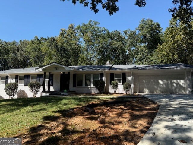 4405 Bakers Ferry Road Southwest Atlanta, GA 30331 - Photo 2 of 18 a front view of a house with a yard