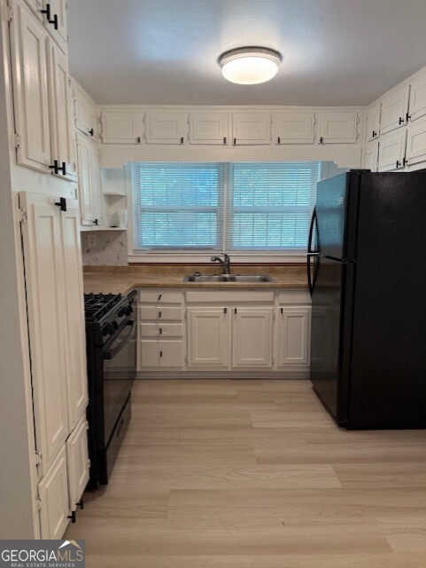 4405 Bakers Ferry Road Southwest Atlanta, GA 30331 - Photo 7 of 18 a kitchen with stainless steel appliances granite countertop a refrigerator and a stove top oven