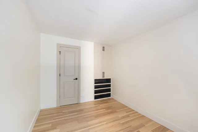 a view of an empty room and wooden floor