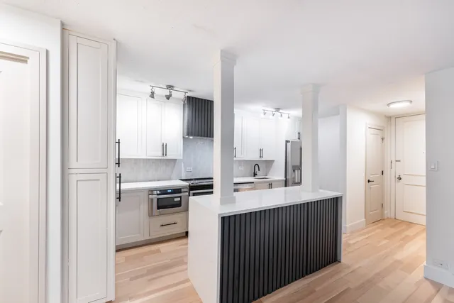 a kitchen with a sink and a refrigerator