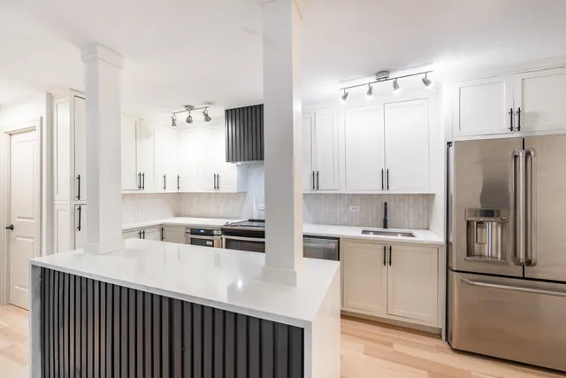 a kitchen with stainless steel appliances a refrigerator sink and cabinets