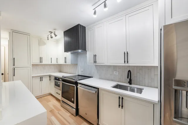 a kitchen with a sink stove and refrigerator