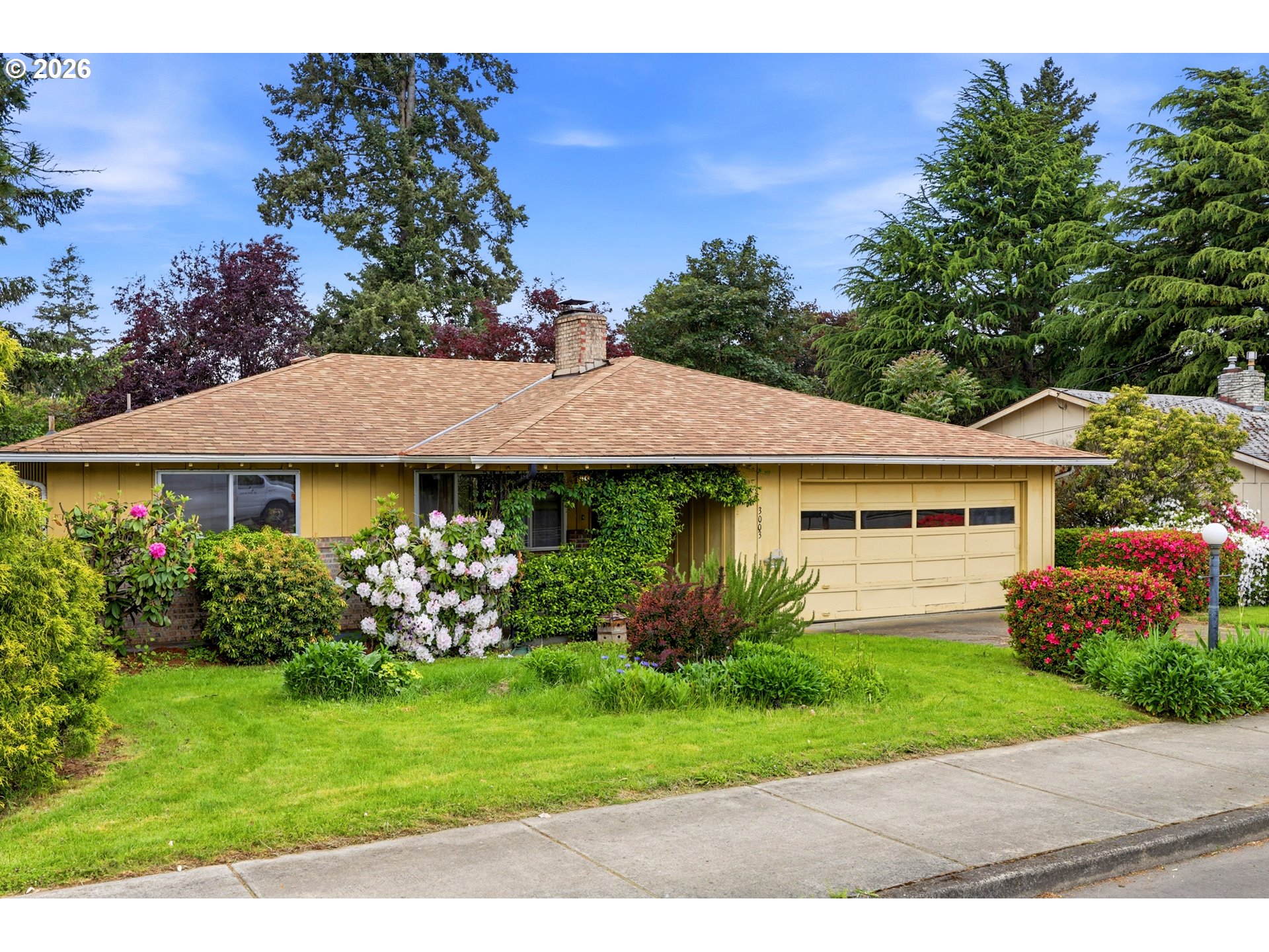 3003 Southeast 162nd Avenue Portland, OR 97236 - Photo 2 of 41 a view of a house with a garden