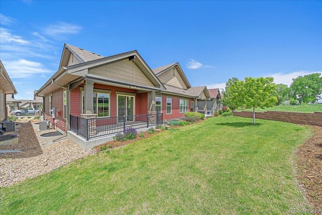 a front view of a house with swimming pool having outdoor seating