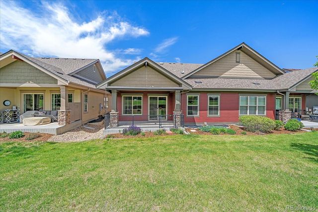a view of a house with a small yard and wooden fence