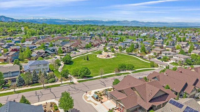 an aerial view of a residential houses with outdoor space and a lake view