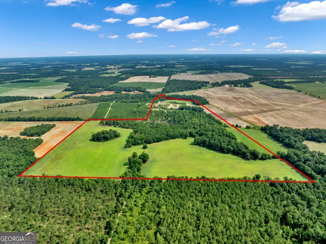 an aerial view of a houses with a yard
