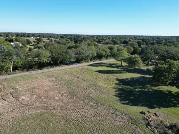 a view of a field with an trees