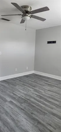a view of a room with wooden floor