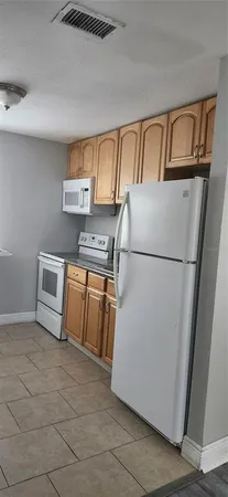 a utility room with cabinets washer and dryer