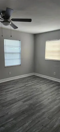 a view of a room with wooden floor and window