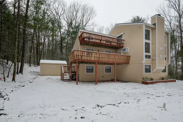 a view of a blue house with a yard
