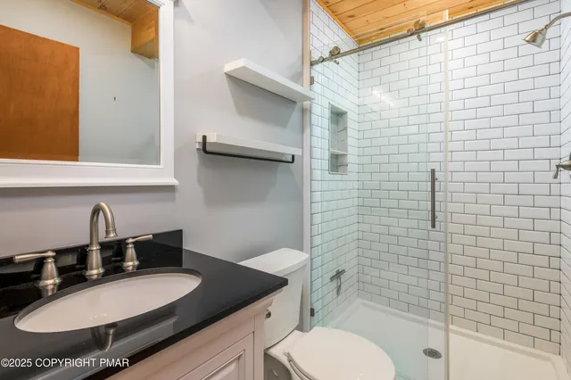 a bedroom with a bed and a night stand