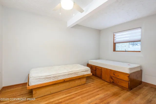a view of a room with wooden floor and a window