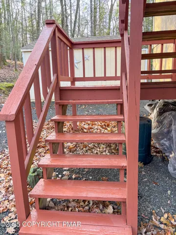 a view of a back yard with a wooden fence