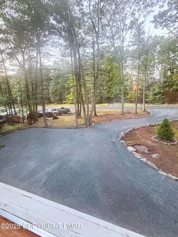 a view of a field with trees in the background