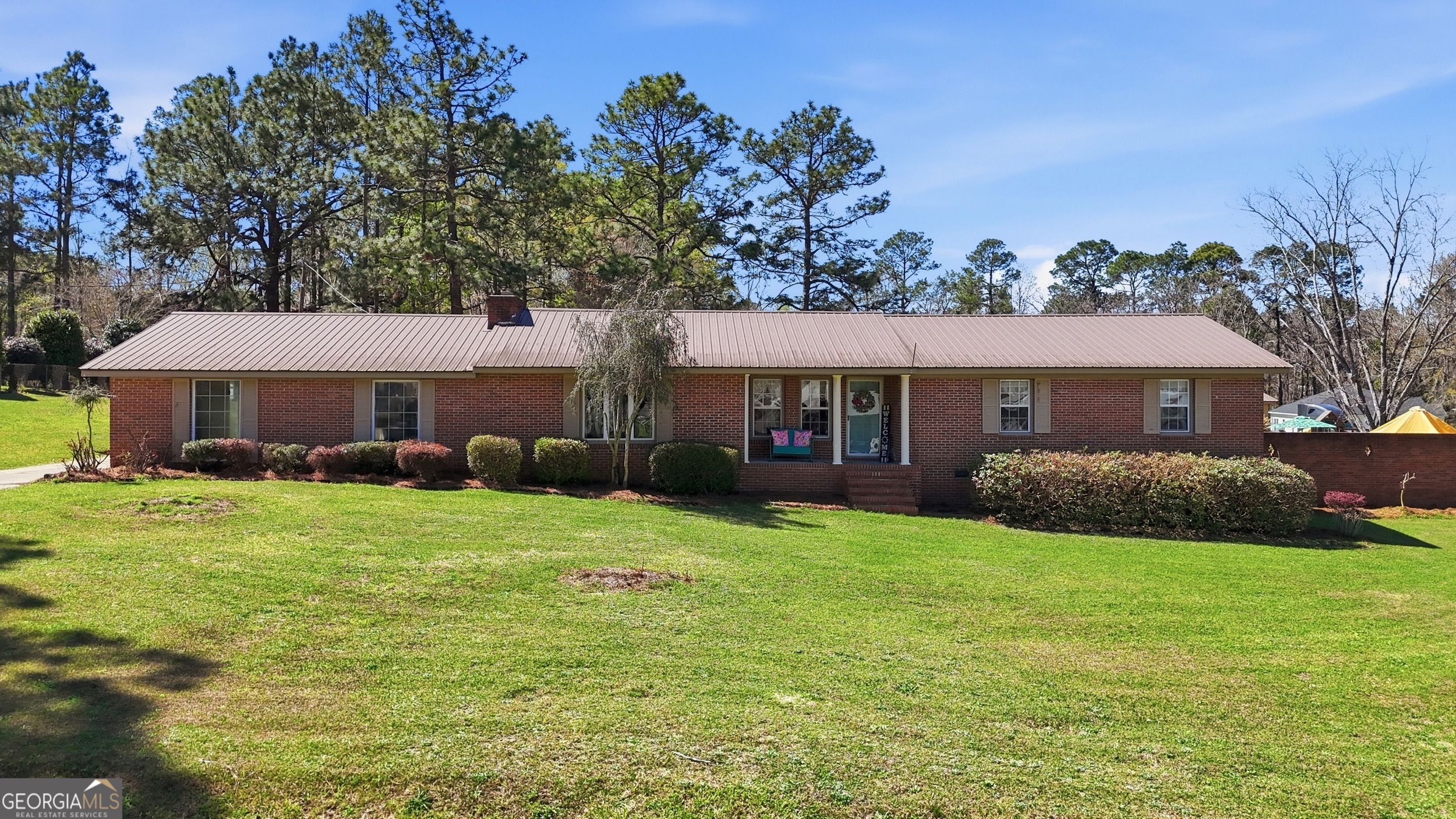 333 Rainbow Ridge Swainsboro, GA 30401 - Photo 1 of 46 a front view of a house with a garden and trees