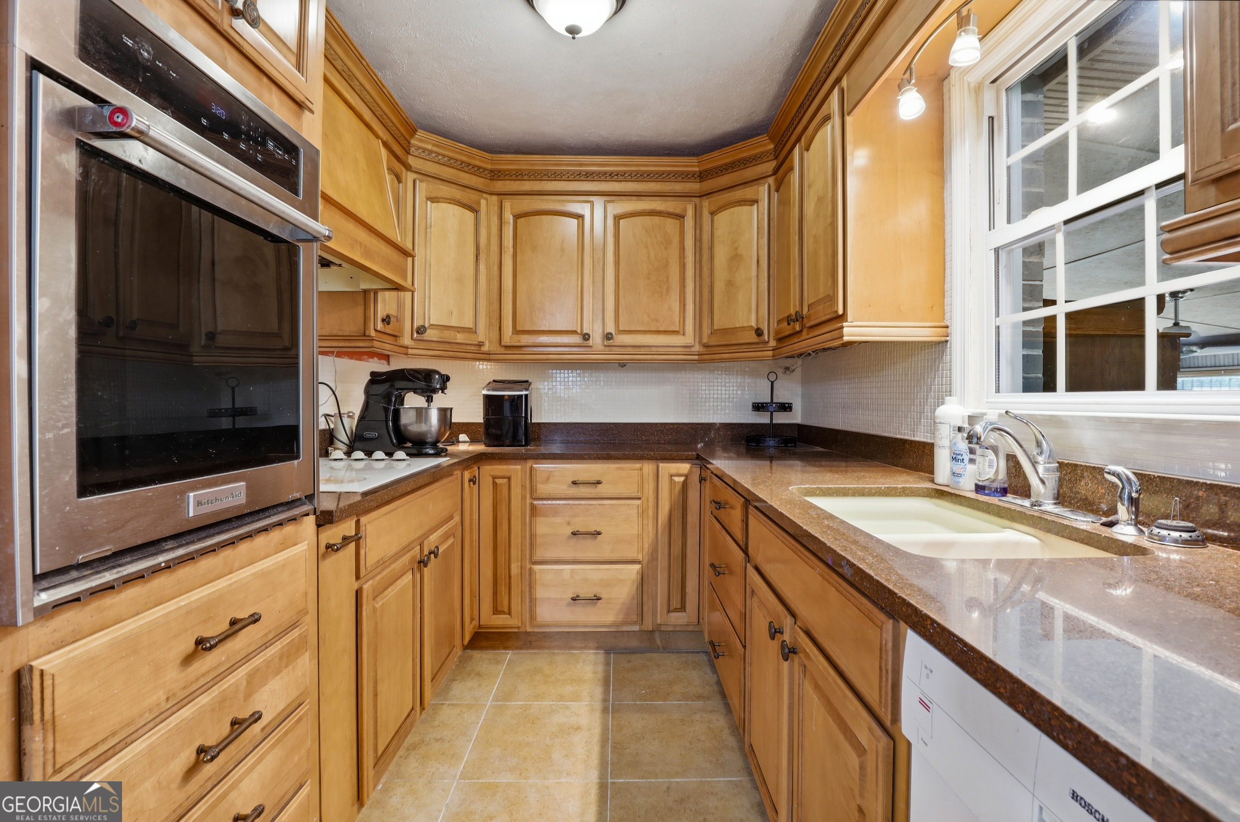 333 Rainbow Ridge Swainsboro, GA 30401 - Photo 14 of 46 a kitchen with granite countertop a sink a stove and cabinets