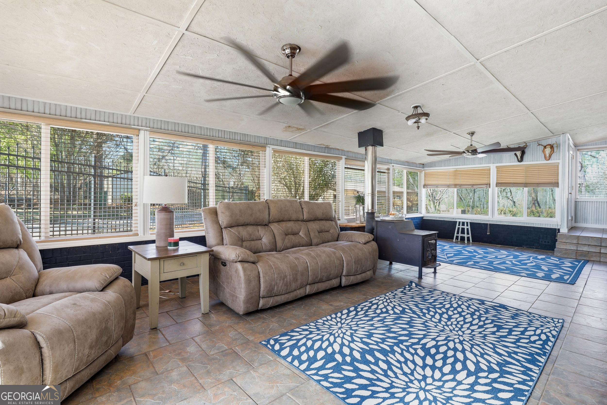 333 Rainbow Ridge Swainsboro, GA 30401 - Photo 25 of 46 a living room with furniture a ceiling fan and a large window