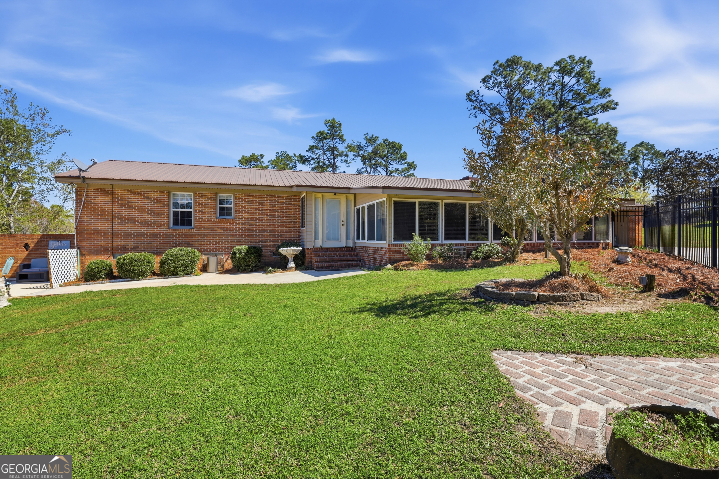 333 Rainbow Ridge Swainsboro, GA 30401 - Photo 26 of 46 a front view of a house with garden and a yard