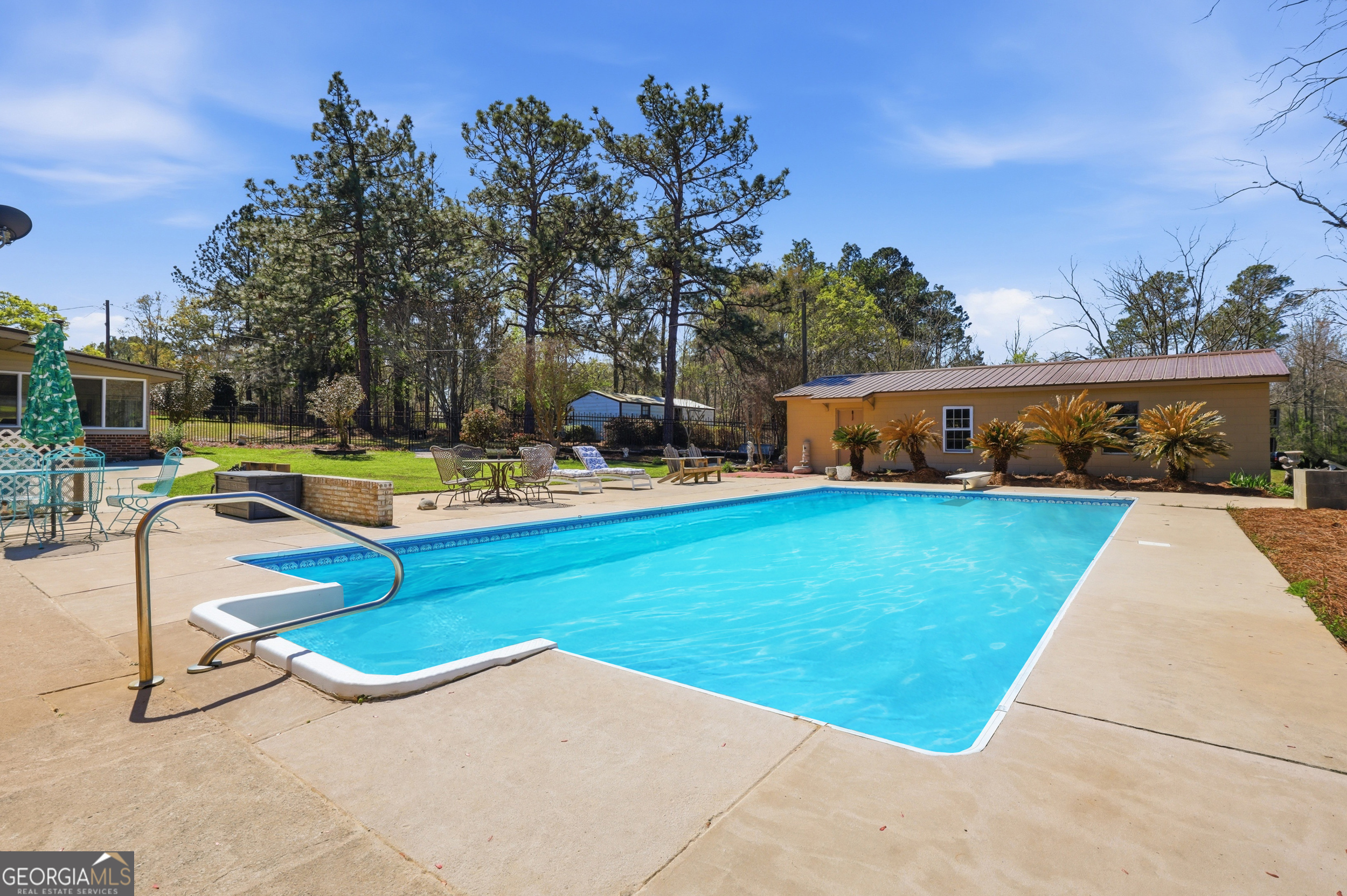 333 Rainbow Ridge Swainsboro, GA 30401 - Photo 30 of 46 a view of a swimming pool with a lounge chairs