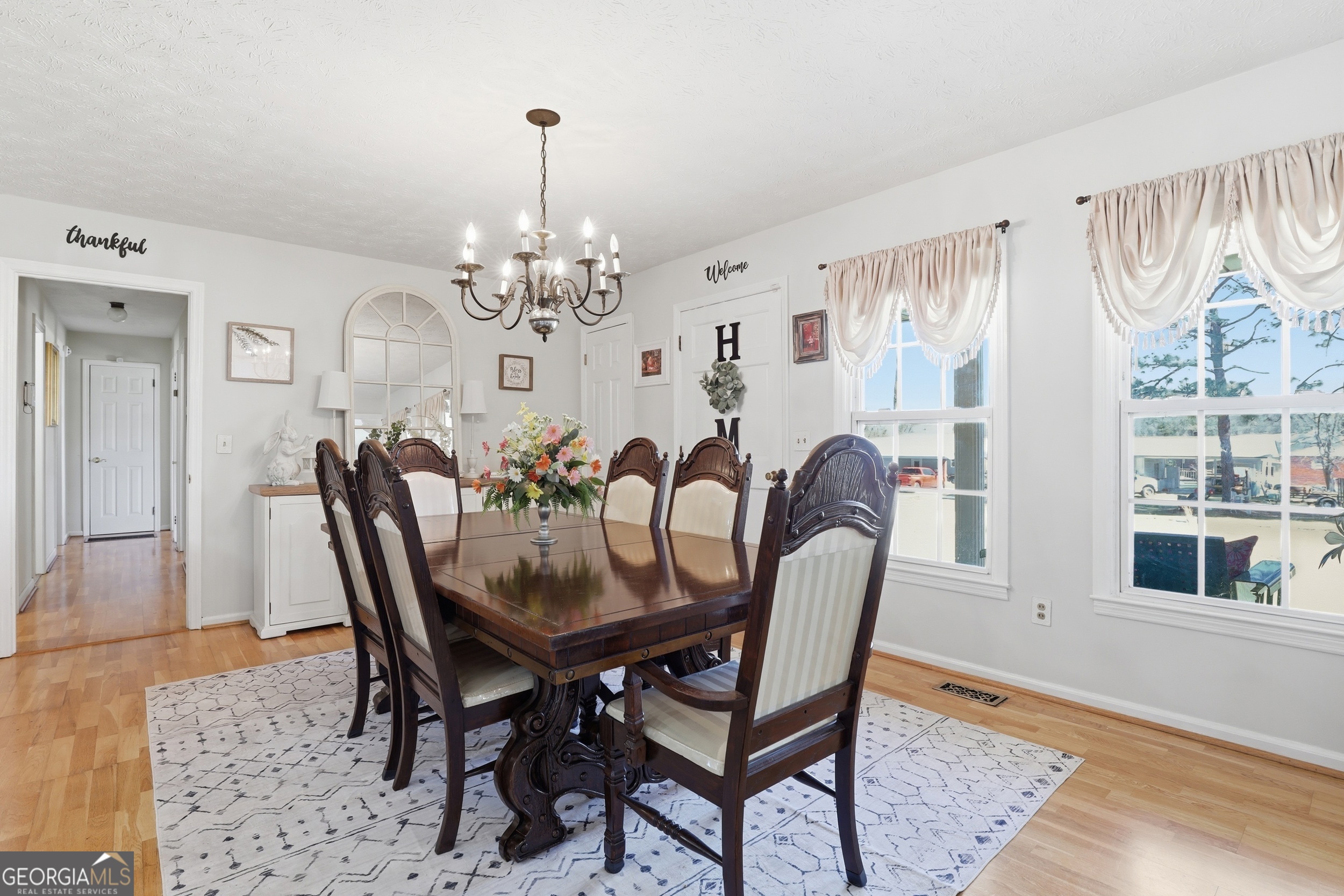 333 Rainbow Ridge Swainsboro, GA 30401 - Photo 9 of 46 a dining room with furniture a chandelier and wooden floor