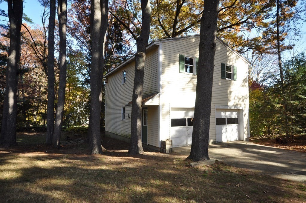 46 Concord Road Acton, MA 01720 - Photo 2 of 33 a backyard of a house with lots of green space