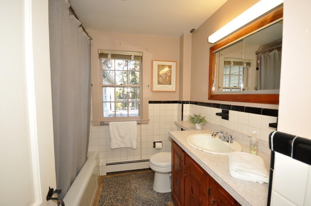 46 Concord Road Acton, MA 01720 - Photo 21 of 33 a bathroom with a sink a toilet and shower
