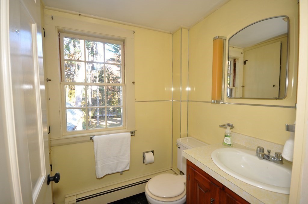 46 Concord Road Acton, MA 01720 - Photo 22 of 33 a bathroom with a sink toilet a mirror and shower