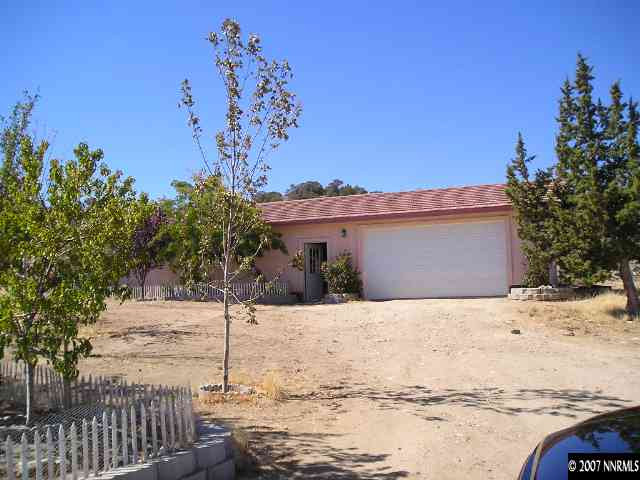 14020 North Red Rock Road Reno, NV 89508 - Photo 4 of 9 a street view with wooden fence and plants