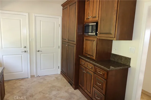 a living room with a fireplace and a floor to ceiling window