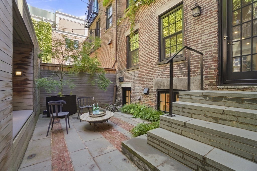 6 Strong Place Boston, MA 02114 - Photo 13 of 38 a view of a patio with chair and table potted plants